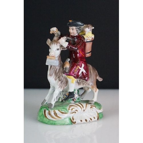 60 - Pair of 19th century Derby style figures, The Welch Tailor and Wife, he seated astride a goat, weari... 