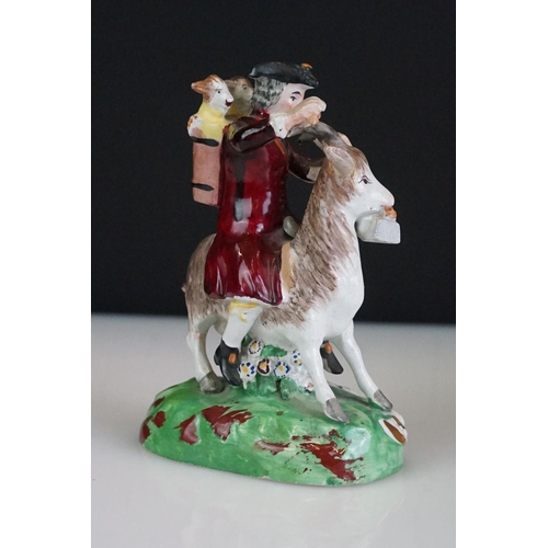 60 - Pair of 19th century Derby style figures, The Welch Tailor and Wife, he seated astride a goat, weari... 