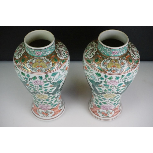 64 - Pair of Chinese Famille Verte vases decorated with dragons & foliage