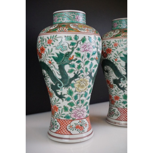 64 - Pair of Chinese Famille Verte vases decorated with dragons & foliage