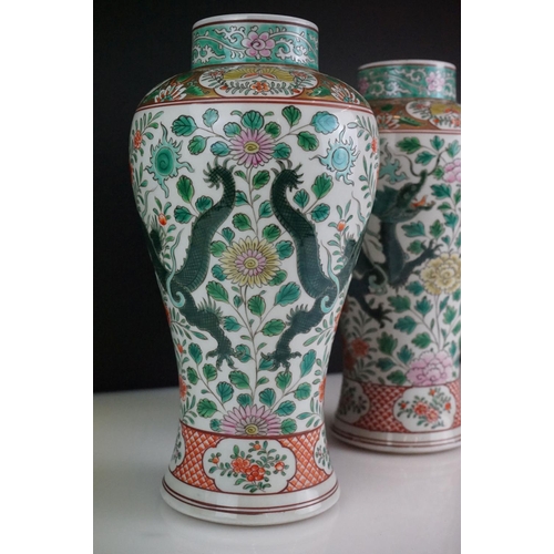 64 - Pair of Chinese Famille Verte vases decorated with dragons & foliage