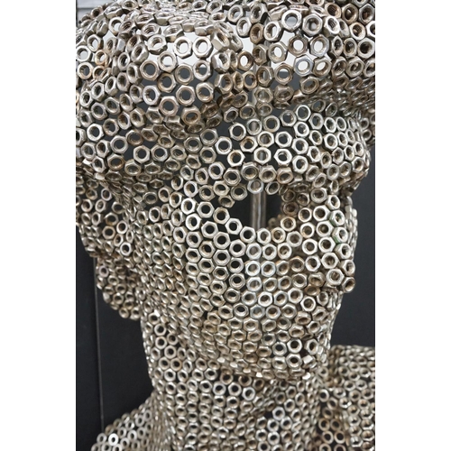 103 - Sculpture of a male head, resembling Michelangelo's David, constructed from metal hexagonal nuts, mo... 