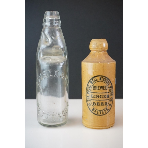 41 - Group of five beer bottles to include a stoneware Malvern Ginger Beer example, a glass Codd bottle, ... 