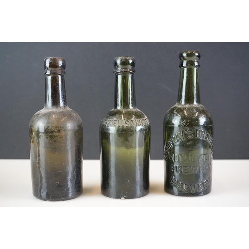 41 - Group of five beer bottles to include a stoneware Malvern Ginger Beer example, a glass Codd bottle, ... 