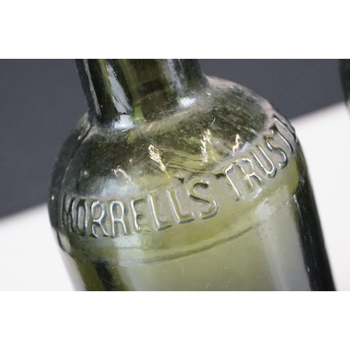 41 - Group of five beer bottles to include a stoneware Malvern Ginger Beer example, a glass Codd bottle, ... 