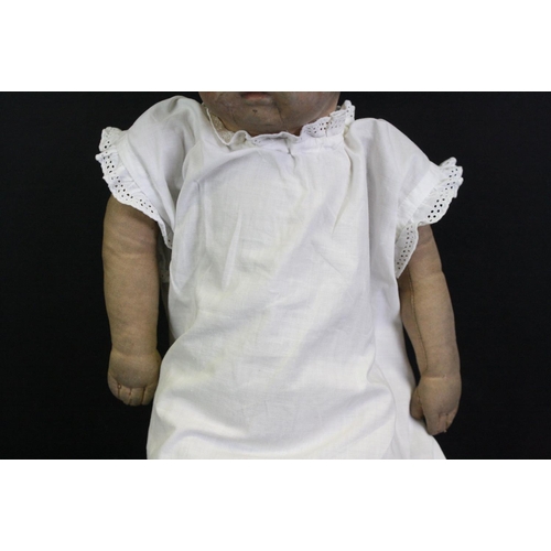 326 - Vintage fabric-covered baby doll dressed in a christening robe, with painted facial features, approx... 