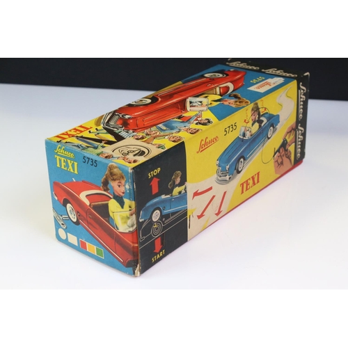 1255 - Original boxed Schuco 5735 Texi tin plate model in red male driver with driver in yellow cap, 3 x wo... 