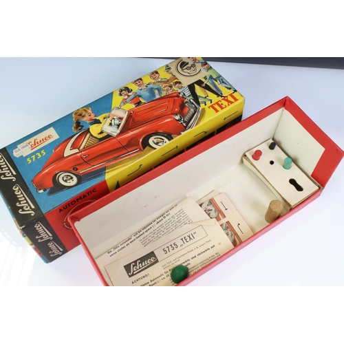 1255 - Original boxed Schuco 5735 Texi tin plate model in red male driver with driver in yellow cap, 3 x wo... 