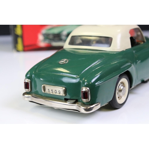 1257 - Original boxed Schuco Elektro Razzia Car 5509 tin plate model in evergreen with cream hood, with ins... 