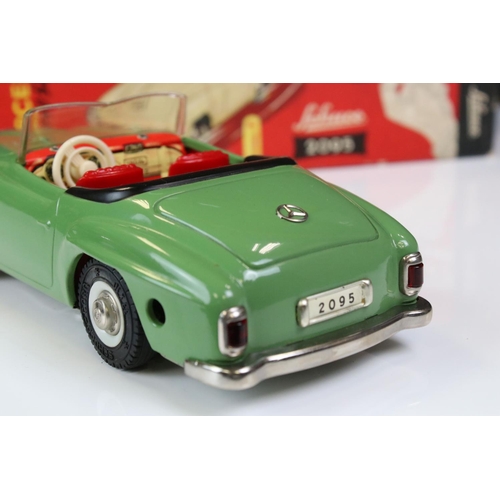 1264 - Boxed Schuco 2095 Mercedes 190SL tin plate clockwork car in green with red interior, complete with k... 