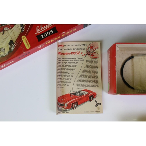 1264 - Boxed Schuco 2095 Mercedes 190SL tin plate clockwork car in green with red interior, complete with k... 