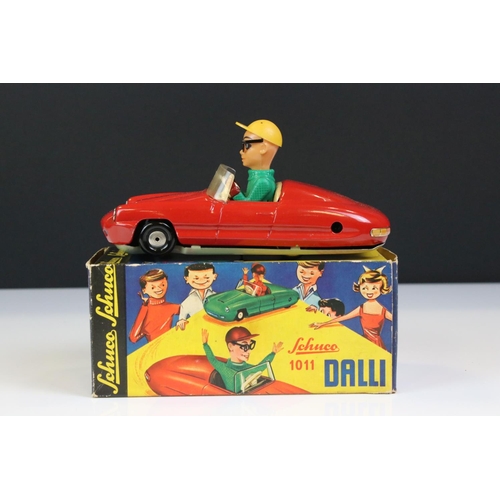 1266 - Boxed Dalli 1011 tin plate clockwork car in red, with driver in yellow cap and black glasses, minima... 