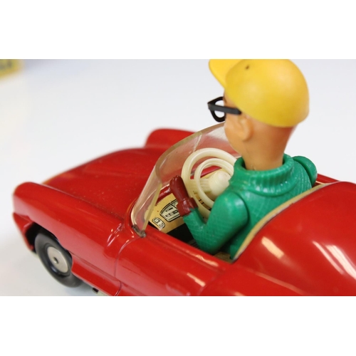 1266 - Boxed Dalli 1011 tin plate clockwork car in red, with driver in yellow cap and black glasses, minima... 