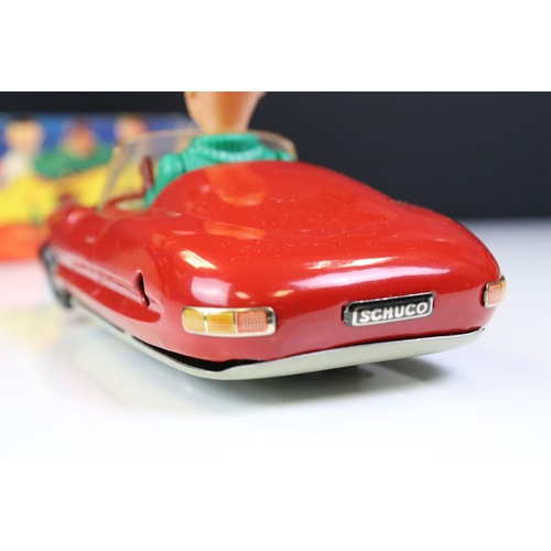 1266 - Boxed Dalli 1011 tin plate clockwork car in red, with driver in yellow cap and black glasses, minima... 