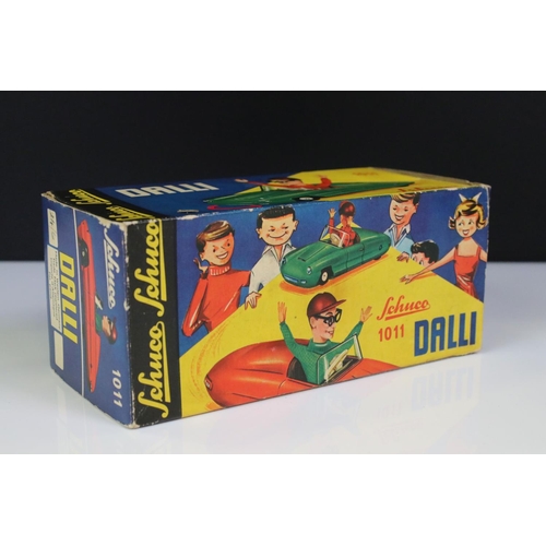 1266 - Boxed Dalli 1011 tin plate clockwork car in red, with driver in yellow cap and black glasses, minima... 