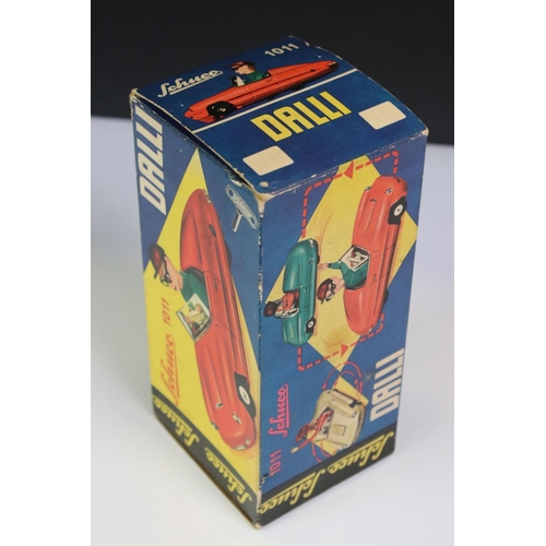 1266 - Boxed Dalli 1011 tin plate clockwork car in red, with driver in yellow cap and black glasses, minima... 