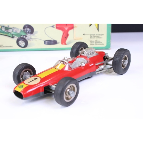 1267 - Boxed Schuco 1079 Dynamo Lotus tin plate F1 racing car with remote controller, in red, race number 1... 