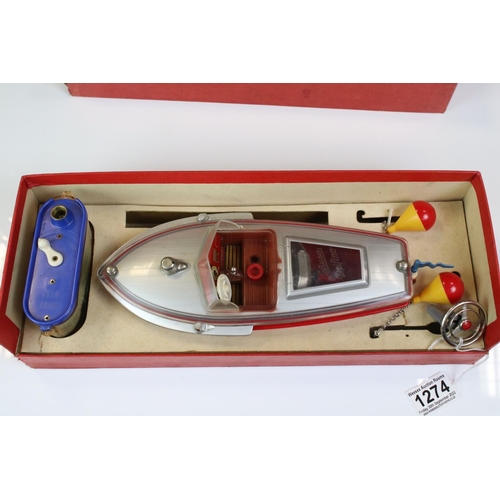 1274 - Boxed Schuco Elektro Delfino 5411 Navico electric motor  boat in silver & red and complete with inst... 