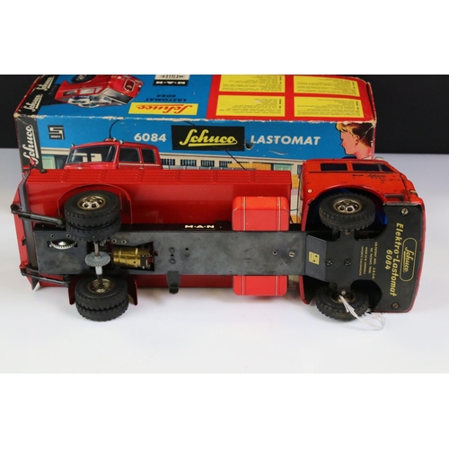 1276 - Boxed Schuco 6084 Lastomat tin plate model in red with instructions and remote control steering whee... 