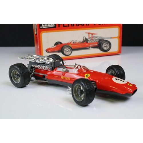 1285 - Two boxed Schuco Formel 2 models, both in red and with keys, one missing rear spoiler, one with FC S... 