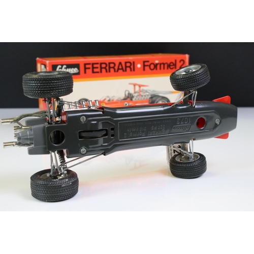 1285 - Two boxed Schuco Formel 2 models, both in red and with keys, one missing rear spoiler, one with FC S... 