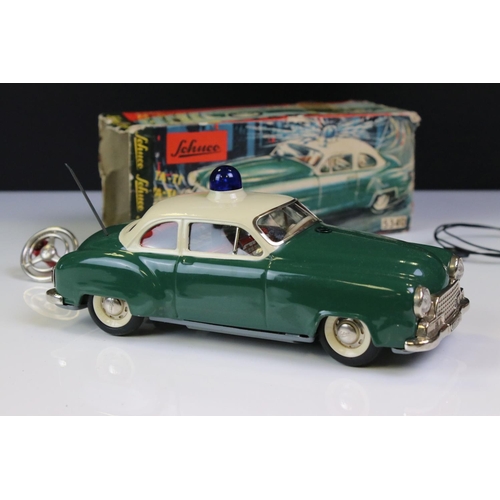 1292 - Schuco battery powered tin plate Alarm Police Car 5340 in green with cream roof and blue light, with... 