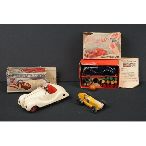 1225 - Two boxed Schuco clockwork tin plate cars to include Telesteering Car 3000 in black complete with al... 