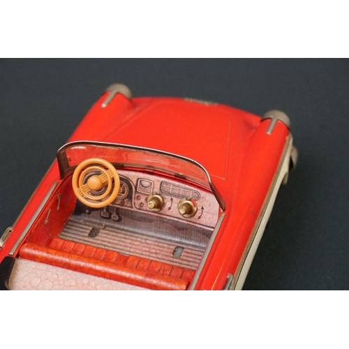 1252 - Schuco Elektro Radio 5710 tinplate model in two tone red and white, brown fins, small hole to windsc... 