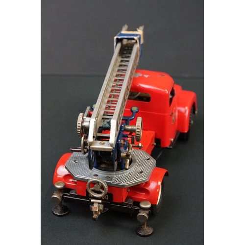 1253 - Original tin plate Schuco Pracision electro construction fire engine model in red, with extending la... 