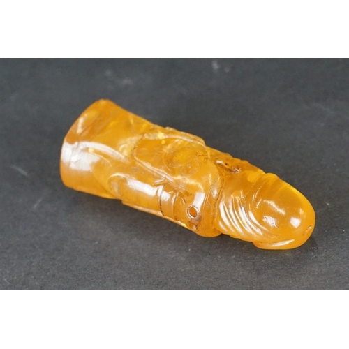 308 - A carved amber Japanese Netsuke pendant in the form of a phallus