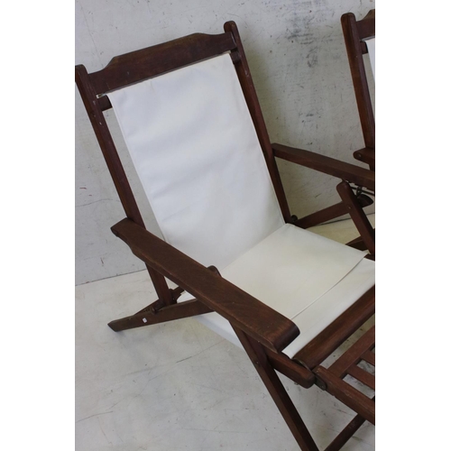 634 - Pair of Hardwood Folding Steamer Chairs with detachable foot rests and new cream canvas seats