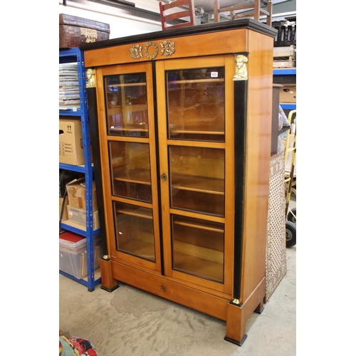 635 - French Empire style Satinwood and Ebonised Display Cabinet with figural metal capped square columns,... 