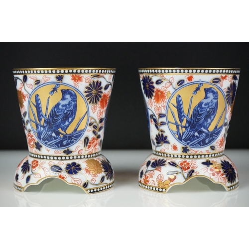 13 - Pair of Coalport Imari vases of tapering form, each raised on three supports, decorated with panels ... 