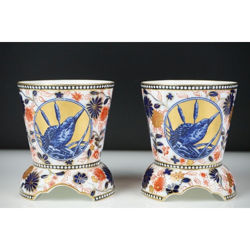 13 - Pair of Coalport Imari vases of tapering form, each raised on three supports, decorated with panels ... 