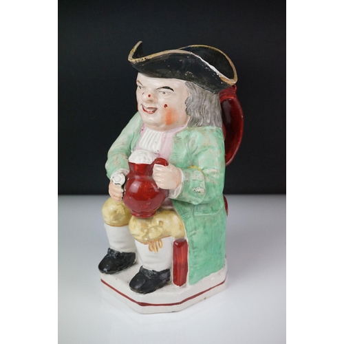 28 - 19th Century Staffordshire Toby jug modelled as Toby Philpott holding a foaming tankard and pipe, ap... 