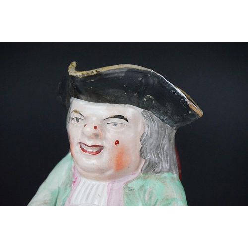 28 - 19th Century Staffordshire Toby jug modelled as Toby Philpott holding a foaming tankard and pipe, ap... 