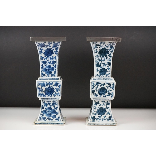 3 - Two similar Chinese ' Gu ' shaped Blue and White Vases decorated with flowers, square white metal ri... 