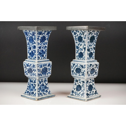 3 - Two similar Chinese ' Gu ' shaped Blue and White Vases decorated with flowers, square white metal ri... 