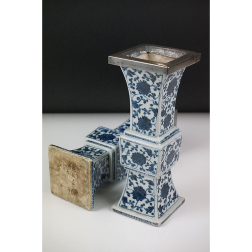 3 - Two similar Chinese ' Gu ' shaped Blue and White Vases decorated with flowers, square white metal ri... 