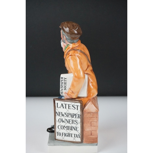 33 - Three Royal Doulton porcelain figures to include ' The Newsvendor ', no. HN 2891, 21cm high, and two... 