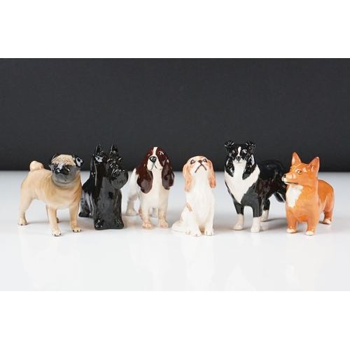 67 - Six Beswick porcelain dog figures, to include a Sheepdog, Scottie, Pug, Corgi, Cocker Spaniel and a ... 