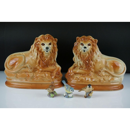 73 - Pair of Staffordshire seated lions with glass eyes, approx 27cm wide, together with three Royal Worc... 