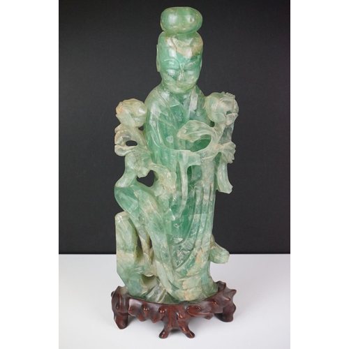 126 - Chinese carved jade figure of Guanyin in robed dress, standing holding a flower, with a bird standin... 