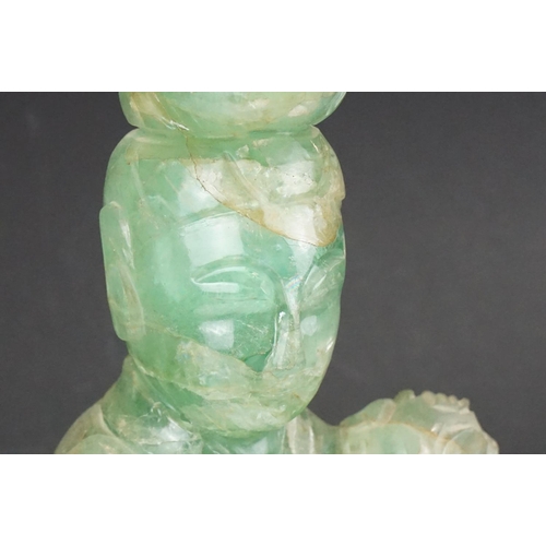 126 - Chinese carved jade figure of Guanyin in robed dress, standing holding a flower, with a bird standin... 