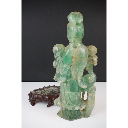 126 - Chinese carved jade figure of Guanyin in robed dress, standing holding a flower, with a bird standin... 