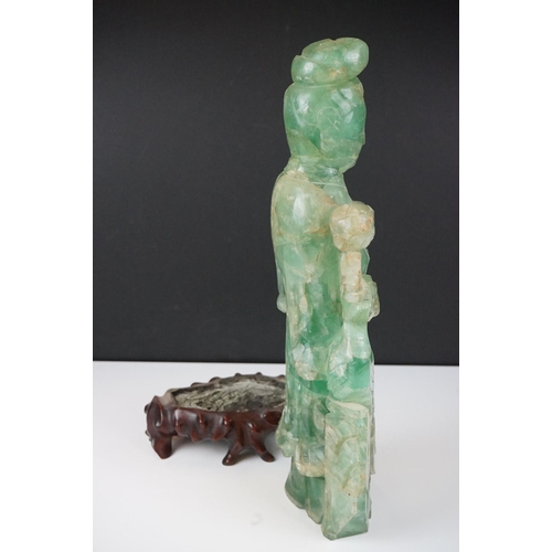 126 - Chinese carved jade figure of Guanyin in robed dress, standing holding a flower, with a bird standin... 