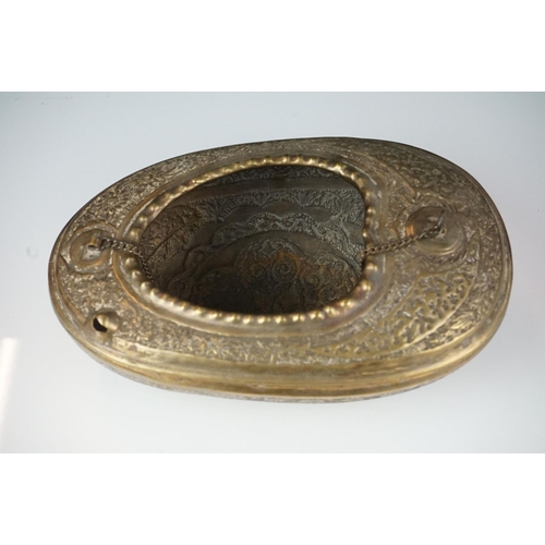 132 - 19th Century Persian brass Kashkul 'begging bowl' heavily embossed and chased with floral and scroll... 