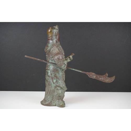 138 - Chinese bronze warrior statue of Guan Gong Yu standing holding a weapon, approx 27cm high