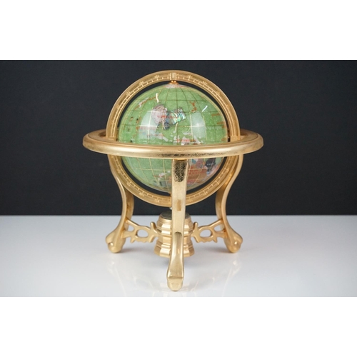 147 - Table top globe made from semi precious stone with compass set to base, raised on three gilt metal l... 