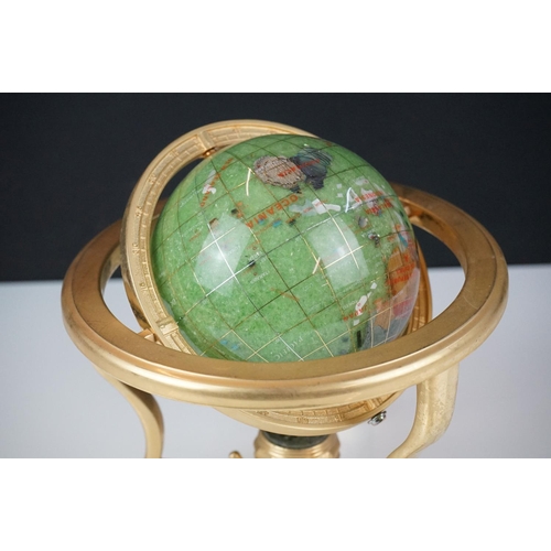 147 - Table top globe made from semi precious stone with compass set to base, raised on three gilt metal l... 